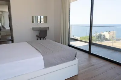 a bedroom with a bed and a view of the ocean at 3 bdr aprt, best seaview, rooftop pool - LCGR in Praia