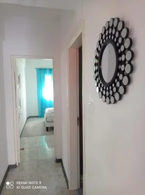 a mirror hanging on a wall in a room at Lovely Apartment In Mindelo City Center in Mindelo