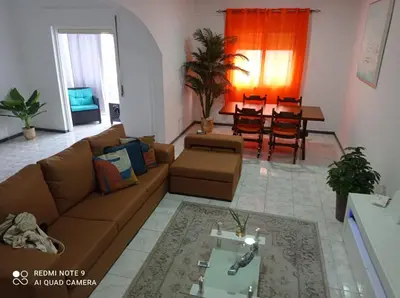 a living room with a couch and a table at Lovely Apartment In Mindelo City Center in Mindelo