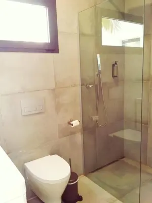 a bathroom with a shower and a toilet at Luxury Beach Villa, Praia de Chaves, Boa Vista in Boa Ventura