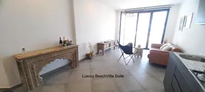 a living room with a fireplace and a couch at Luxury Beach Villa, Praia de Chaves, Boa Vista in Boa Ventura