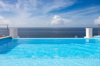 a swimming pool with a view of the ocean at 3 bdr aprt, amazing seaview, rooftop pool - LCGR in Praia