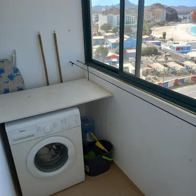 a washing machine in a room with a window at Recanto Verde Cara in Mindelo