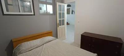 a bedroom with a bed and a dresser and a door at Kaza Jindung in Mindelo