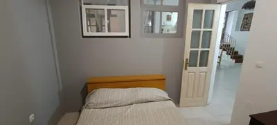 a bedroom with a bed and a door and a staircase at Kaza Jindung in Mindelo