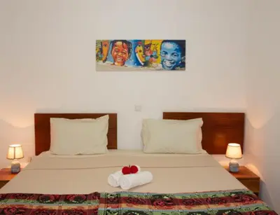 a bedroom with a bed with a red bow on it at Casa Maria Apartments in Santa Maria