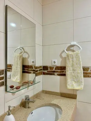 a bathroom with a sink and a mirror at Casa Maria Apartments in Santa Maria