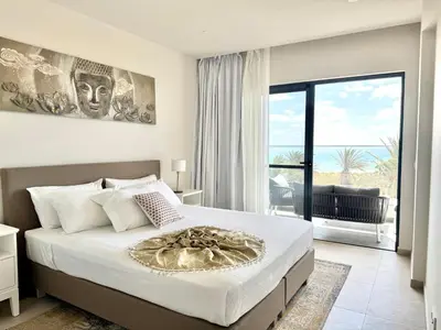 a bedroom with a bed with a view of the ocean at SunSet in Santa Maria