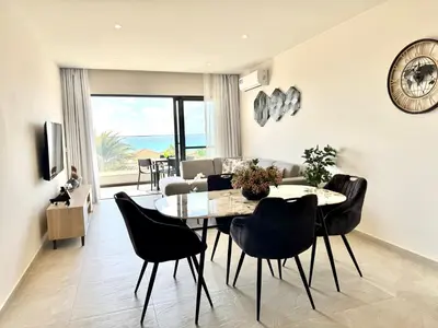 a living room with a table and chairs and a couch at SunSet in Santa Maria