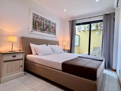 a bedroom with a large bed and a window at Sunrise in Santa Maria