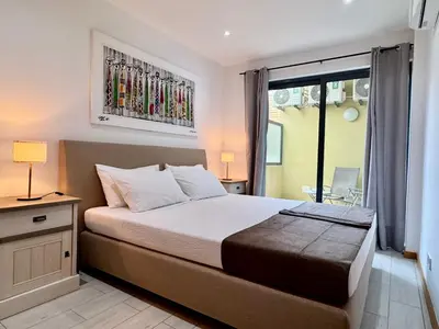 a bedroom with a bed and a large window at Sunrise in Santa Maria