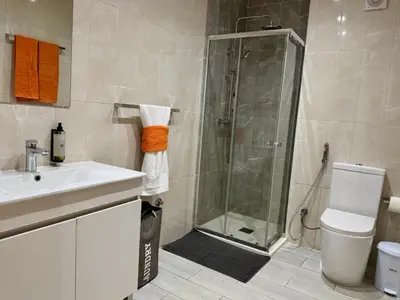 a bathroom with a shower and a sink and a toilet at Sunrise in Santa Maria