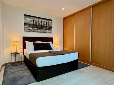 a bedroom with a bed and a painting on the wall at Sunrise in Santa Maria