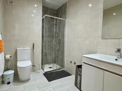a bathroom with a shower and a toilet and a sink at Sunrise in Santa Maria