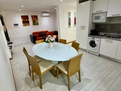 a kitchen and living room with a table and chairs at Sunrise in Santa Maria