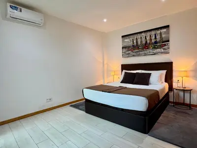 a bedroom with a bed and a painting on the wall at Sunrise in Santa Maria