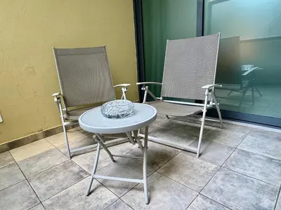 two chairs and a table in a room at Sunrise in Santa Maria