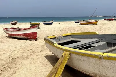 a group of boats sitting on a beach at Villa GÊMEO vue mer, piscine accès privé plage in Calheta Do Maio