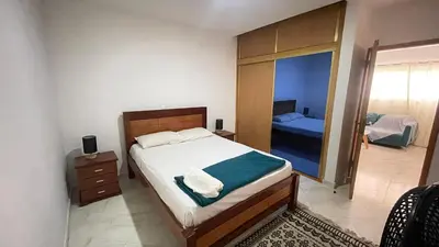 a bedroom with a large bed and a mirror at Quick Stay in Praia #2 in Praia