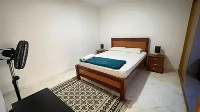 a bedroom with a bed with a blue blanket on it at Quick Stay in Praia #2 in Praia
