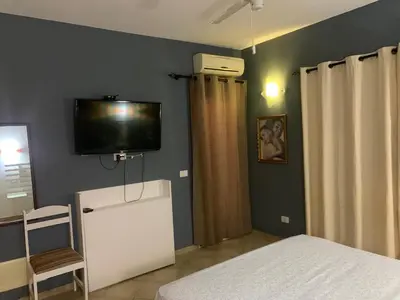 a bedroom with a tv on the wall and a bed at Apartamento Antunes in Santa Maria