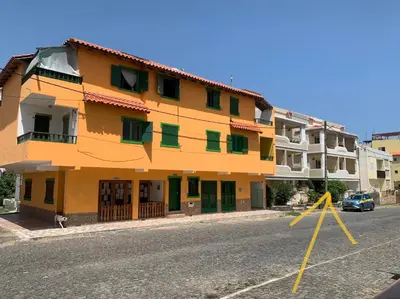 an orange building on the side of a street at Apartamento Antunes in Santa Maria