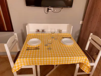 a table with a yellow and white checkered table cloth at Apartamento Antunes in Santa Maria
