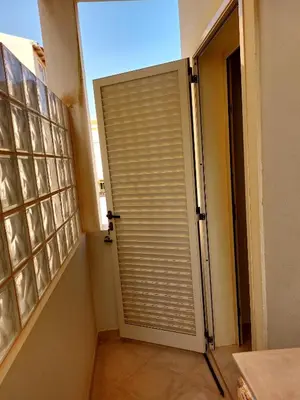 a door to a room with a window with blinds at Apartamento Antunes in Santa Maria