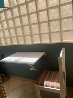 a small room with a window and a shelf at Apartamento Antunes in Santa Maria
