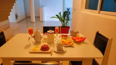 a table with plates of food on it at Splanada poilon in Assomada