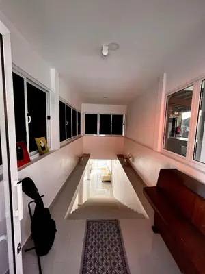 a living room with a couch and some windows at Splanada poilon in Assomada
