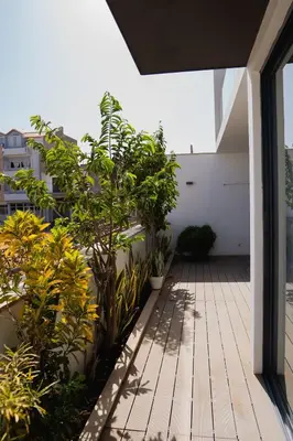 an open balcony with plants on a building at Kriol Guest House in Praia