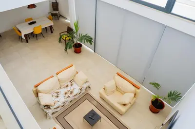 an overhead view of a living room with two chairs and a table at Kriol Guest House in Praia