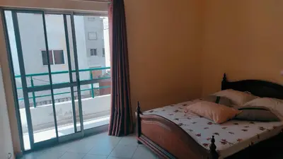 a bedroom with a bed and a large window at Casa de Gá in Mindelo
