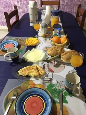 a table with plates of food on top at Casa de Gá in Mindelo