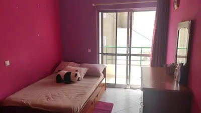 a room with a bed with a stuffed animal on it at Casa de Gá in Mindelo