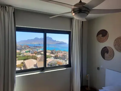 a room with a window with a view of the ocean at Bellavista in Mindelo