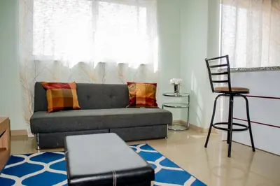 a living room with a couch and a chair at Comfortable and Cozy Apartments in Praia