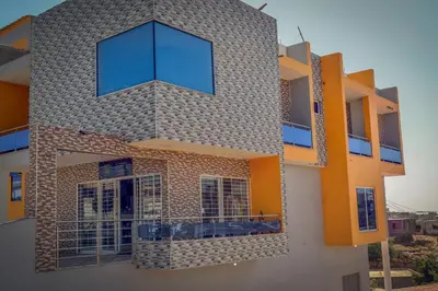 a building with a large window on the side of it at Comfortable and Cozy Apartments in Praia
