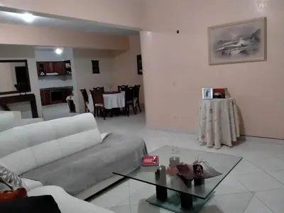 a living room with a couch and a table at Kaza Mamai di Fora in Calheta de São Miguel