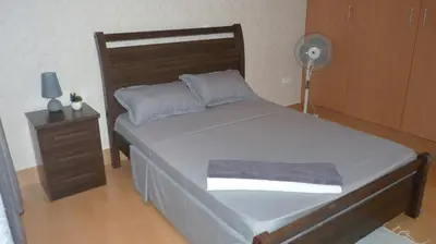a bedroom with a large bed and a fan at KAZARÃO DI MAVETE- Guesthouse in Praia