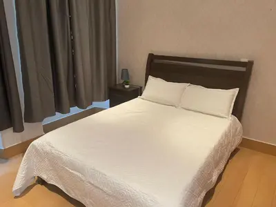a bed with white sheets and pillows in a bedroom at KAZARÃO DI MAVETE- Guesthouse in Praia
