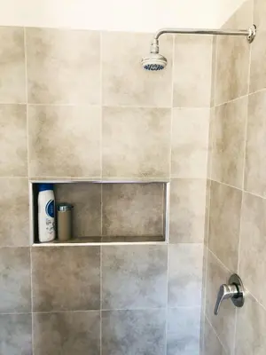 a bathroom with a shower with a glass door at Boavista Beach Apartment in Sal Rei