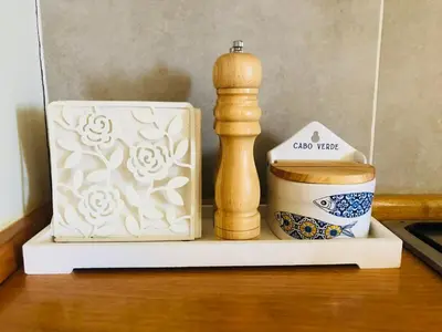 a shelf with a cup and a wooden object next to a coffee mug at Boavista Beach Apartment in Sal Rei