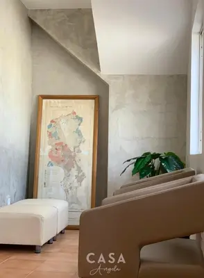 a room with a couch and a painting on the wall at Residencial Casa Ângela in Espargos
