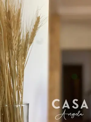 a glass vase filled with wheat germ in front of a fireplace at Residencial Casa Ângela in Espargos