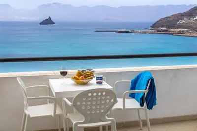 a table and chairs with a view of the ocean at Sky Mariposa sospesa sul mare in Mindelo