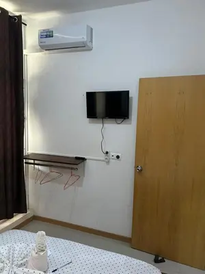 a room with a tv on the wall and a bed at My Flat 1 in Praia