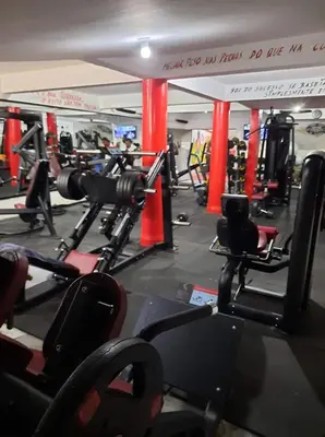 a gym with lots of machines and a sign that reads wait for us to use at My Flat 1 in Praia