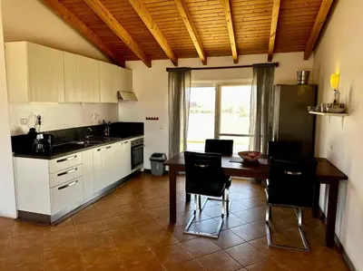a kitchen with a table and chairs and a table and a counter at Spacious Penthouse with Sea View - Boteto U in Sal Rei